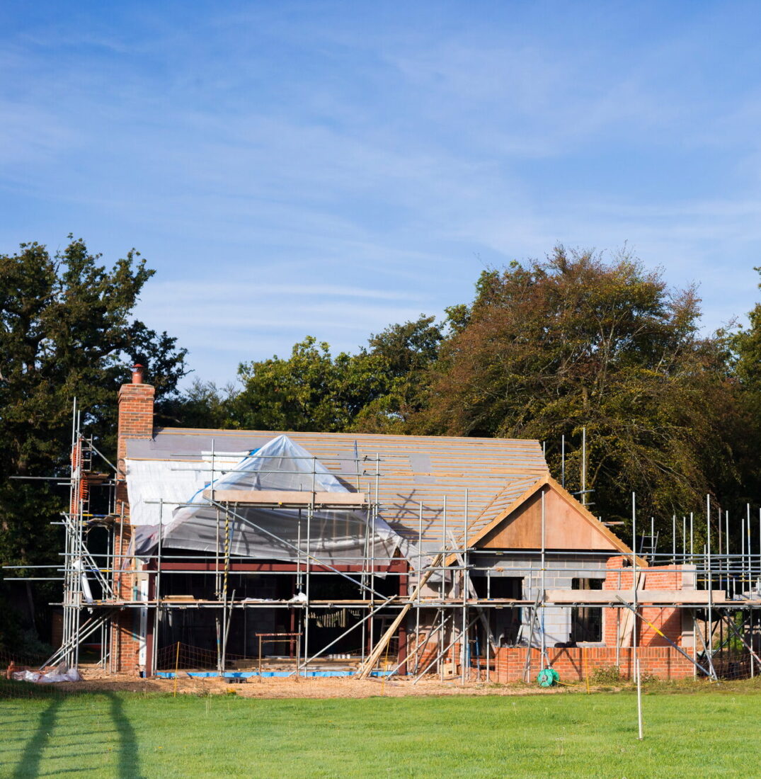 A family home under construction. A building site with scaffolding.
